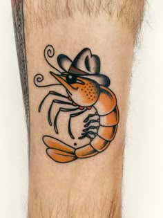 a tattoo on the leg of a man with a crab in it's claws