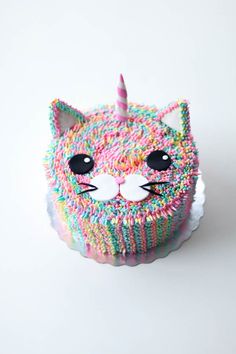 a cake with sprinkles and a cat's face on the top