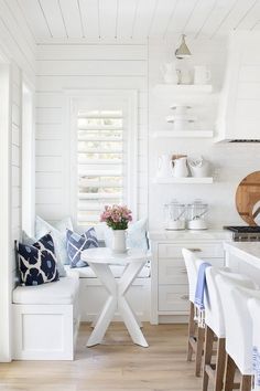 the kitchen is clean and ready for us to eat in it's white cabinets