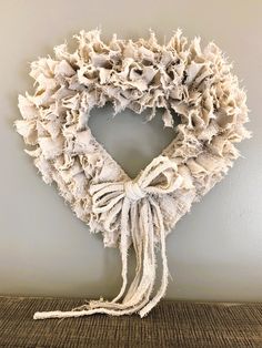 a wreath made out of old clothes hanging on the wall