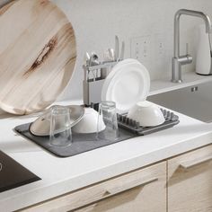 a kitchen counter with dishes and utensils on it