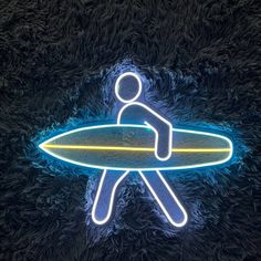 a neon sign with a person holding a surfboard in the middle of it's body