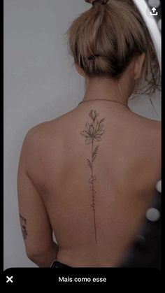 a woman with a flower tattoo on her back