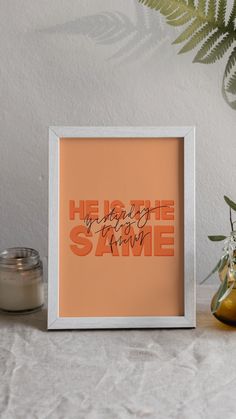 an orange print with the words hello to the same person on it next to some plants