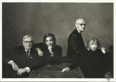 an old black and white photo of three people sitting at a table with their arms around each other