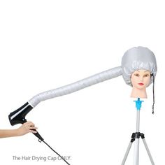 a mannequin with a hair dryer on it's head being held by a tripod