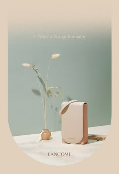 an advertisement for lancome with a vase and plant on the table next to it