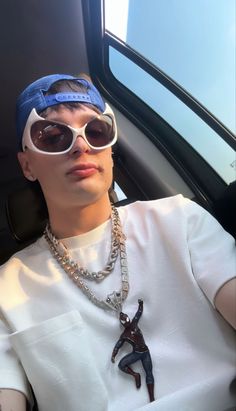 a person wearing sunglasses and a chain around their neck