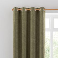 a green curtain hanging in front of a window