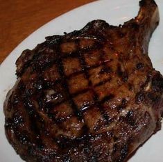 a piece of steak on a white plate