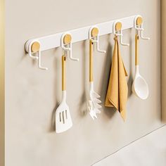 the kitchen utensils are hanging on the wall