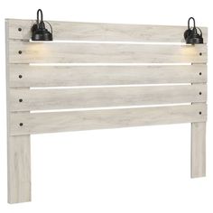 a white wooden headboard with two lights on each side and one light at the top