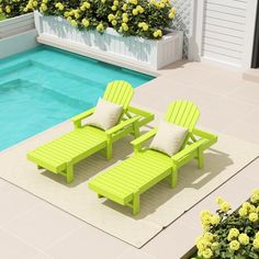 two green lawn chairs next to a swimming pool with yellow flowers in the back ground