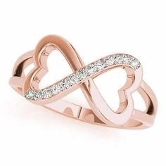 a rose gold ring with diamonds in the shape of two intertwined hearts, on a white background