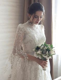 a woman in a wedding dress holding a bouquet