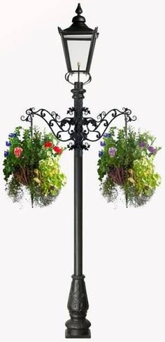 a lamp post with flowers hanging from it's sides and two planters on the top