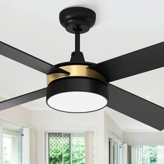 a ceiling fan with two black blades and a gold light on it in a living room