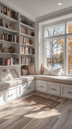 a window seat in the corner of a room with bookshelves on both sides