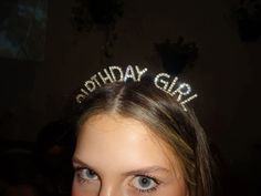 a girl wearing a tiara with the words birthday girl on it's head