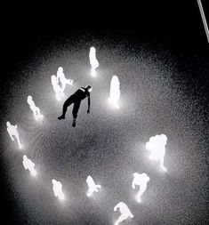 a man flying through the air surrounded by lots of white light emitting from his feet