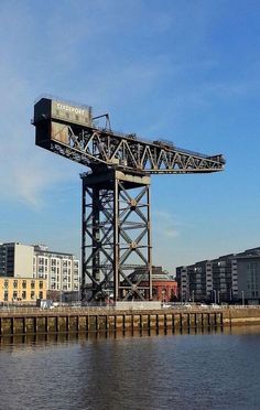 a large crane sitting on top of a bridge over water