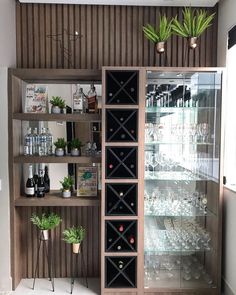 a wine rack with many bottles and glasses on it