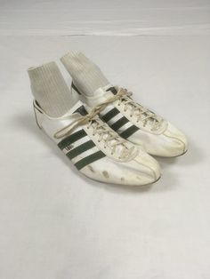 vintage 1970s track sneakers Adidas Quebec made in France original laces dark green suede stripes on white leather w/marks, scuffs, one spike gone rubber partial sole is still flexible front of bottom is hard plastic w/spikes measures, insole-10 7/8" sole-11 1/4" width-3 1/2" height at heel-3 1/4" Vintage Running Sneakers, Adidas Vintage Shoes, Vintage Sports Sneakers With Three Stripes, Vintage Style Sneakers With Three Stripes For Sports, 70s Sneakers, Adidas Vintage, White Leather Shoes, Vintage Sneakers, Green Suede