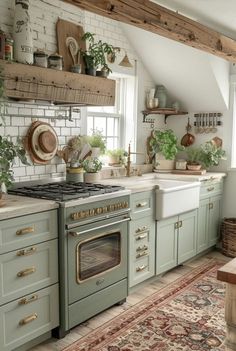 a kitchen with green cabinets and an oven