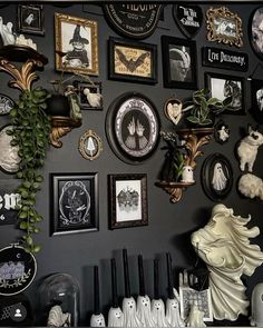 there are many pictures on the wall with black and white decorations above them, along with other items