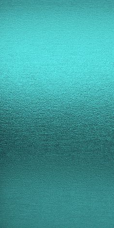 a close up view of a shiny teal colored surface