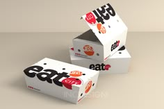 three boxes with different logos on them sitting side by side in front of each other