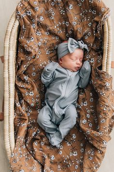 a baby is laying down in a basket