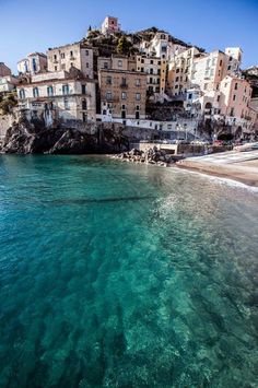 the water is crystal blue and clear in this photo, with buildings on top of it