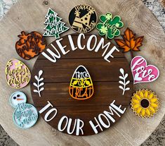 a welcome sign with lots of different magnets on it's side in front of a wooden board