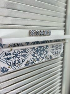 a close up of a metal radiator with blue and white designs on it