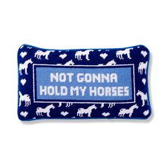 a blue pillow with white horses on it that says, not gon na hold my horses