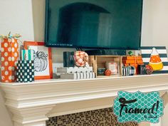 a fireplace mantel decorated for halloween with pumpkins, candy and gift bags on it