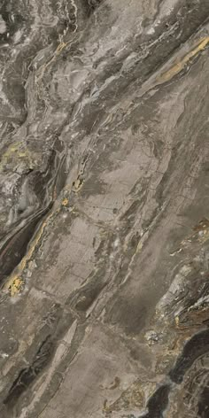 an aerial view of a marbled surface with yellow and black streaks on the ground