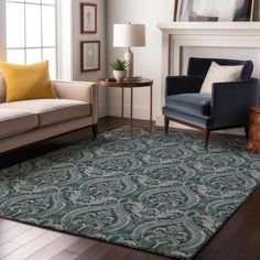 a living room filled with furniture and a rug on top of a hard wood floor