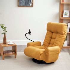 a yellow recliner chair sitting in a living room next to a small end table