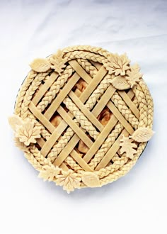 an intricately carved wooden dish on a white surface