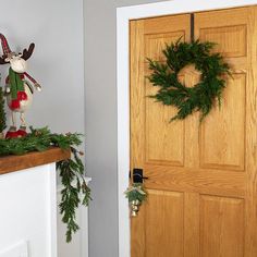 a wooden door with christmas wreaths on it