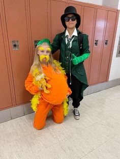 two people dressed in costumes standing next to each other near lockers with doors behind them