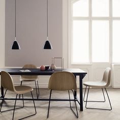 an image of a dining room setting with chairs and a table in the middle that has two pendant lights above it