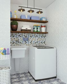 a white washer sitting next to a trash can in a room with tiled walls