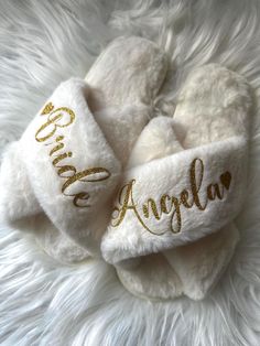 a white and gold personalized hair tie on top of a fluffy white fur rug