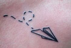 a small tattoo on the back of a woman's neck with an origami design