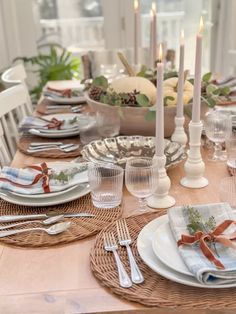 a table set with place settings and candles