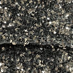 black and silver sequin fabric with lots of small white dots on the top side