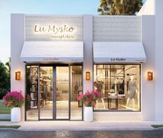 the front entrance to a store with flowers in vases on the windows and doors